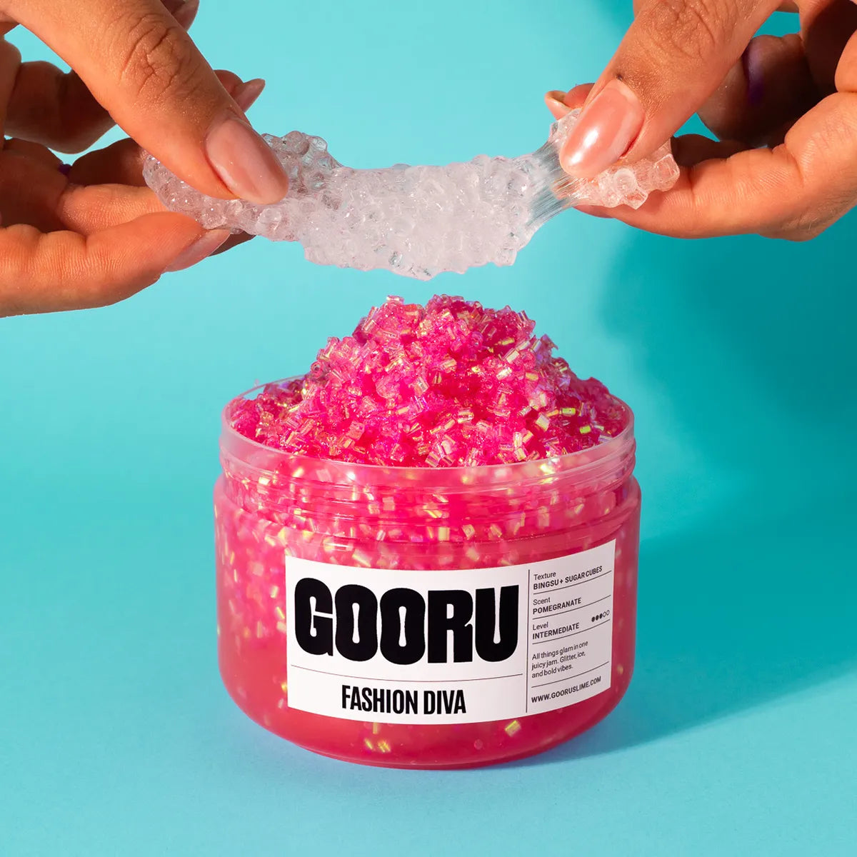 Jar of pink glittery slime with 'GOORU' label on a blue background