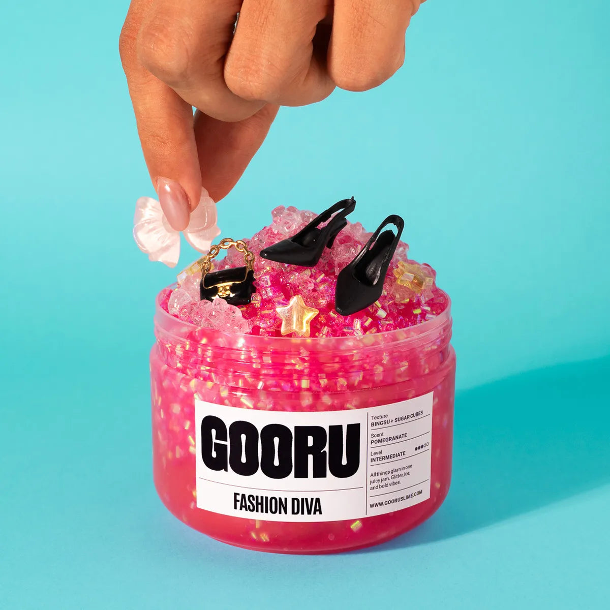 Pink slime jar with decorative items and 'GOORU' label on a blue background