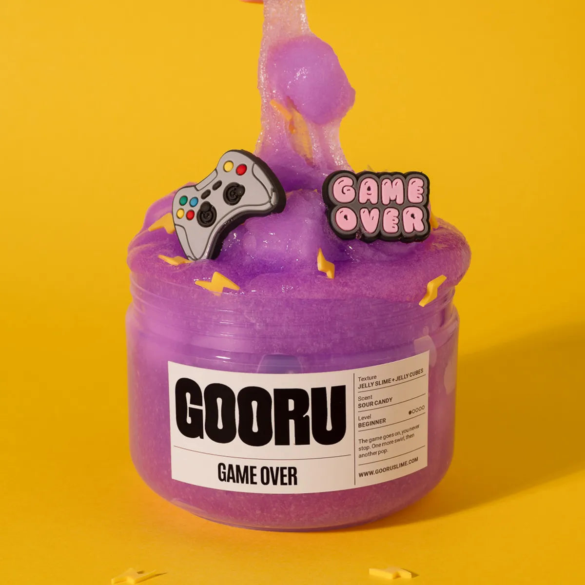 Purple slime jar labeled 'GOORU GAME OVER' with gaming-themed decorations on a yellow background