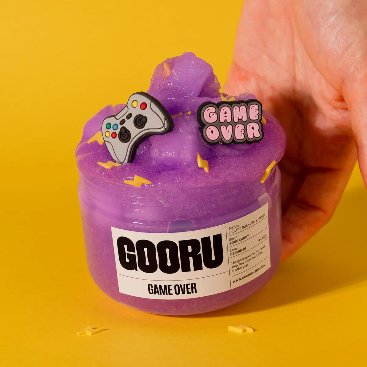Purple slime container with 'Game Over' and controller design on a yellow background