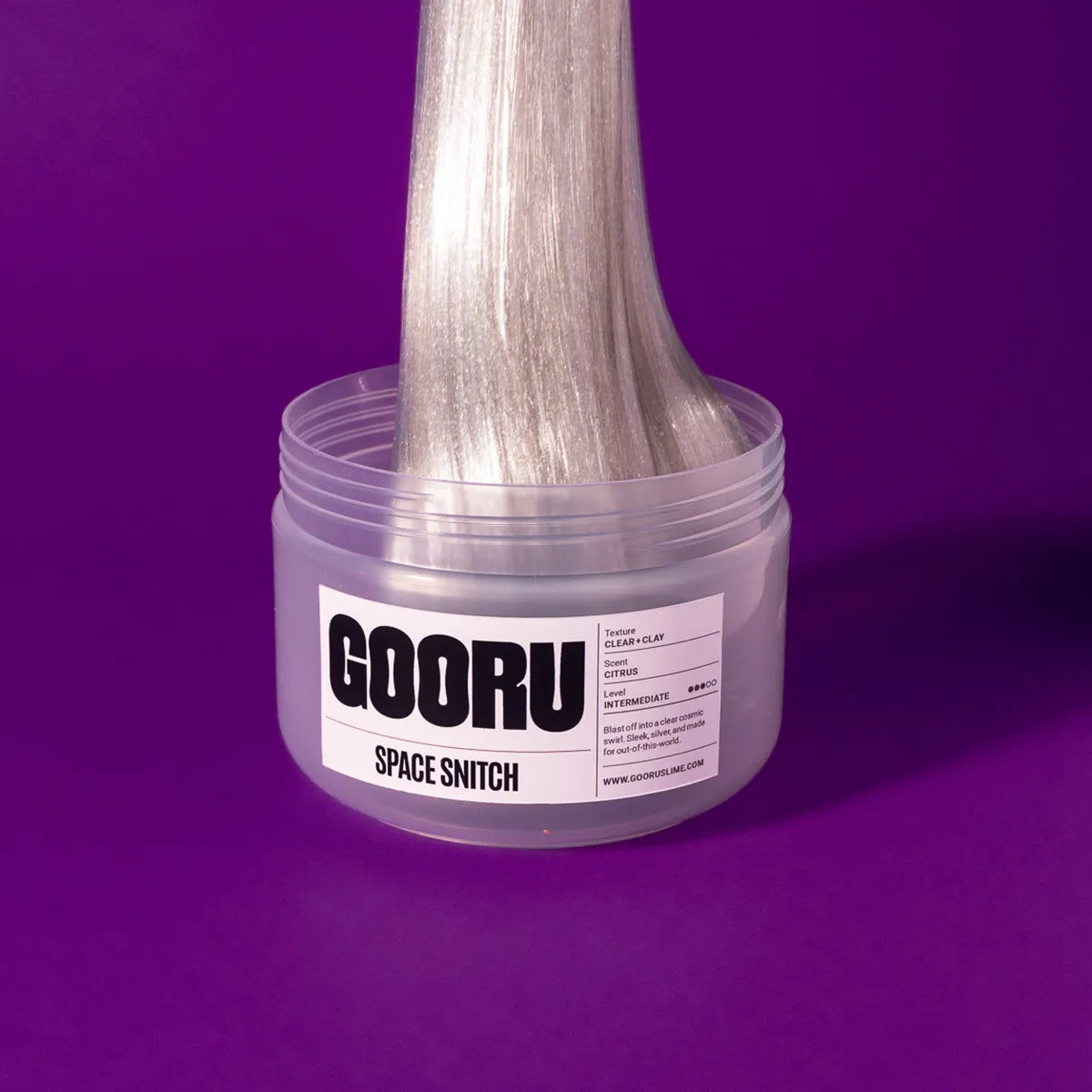 Clear container with metallic slime and 'GOORU' label on a purple background