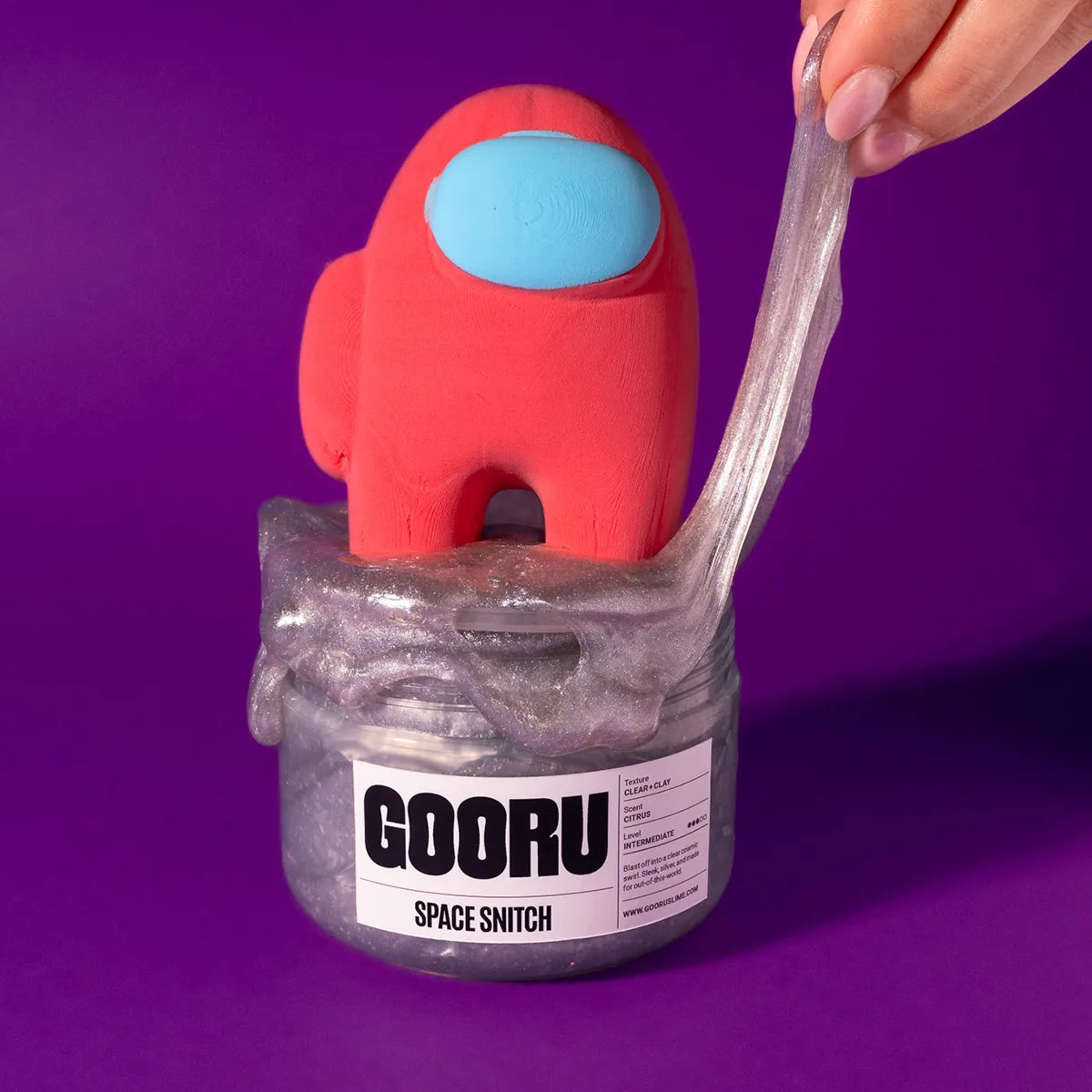 Red and blue character with a slime jar labeled 'GOORU Space Snitch' on a purple background