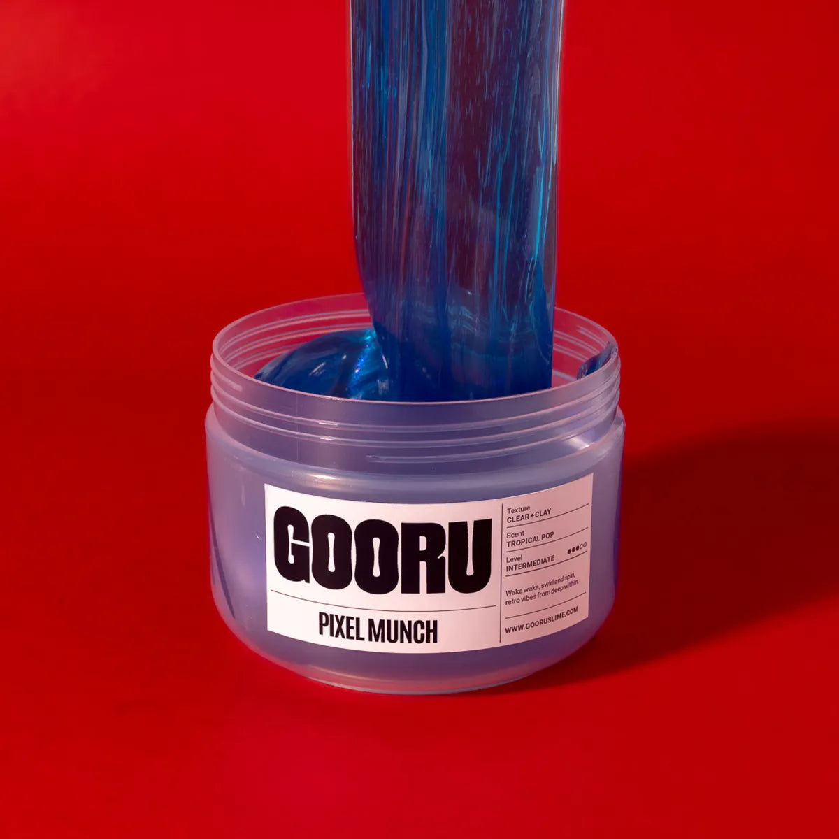 Blue slime being poured from a container labeled 'GOORU Pixel Munch' against a red background