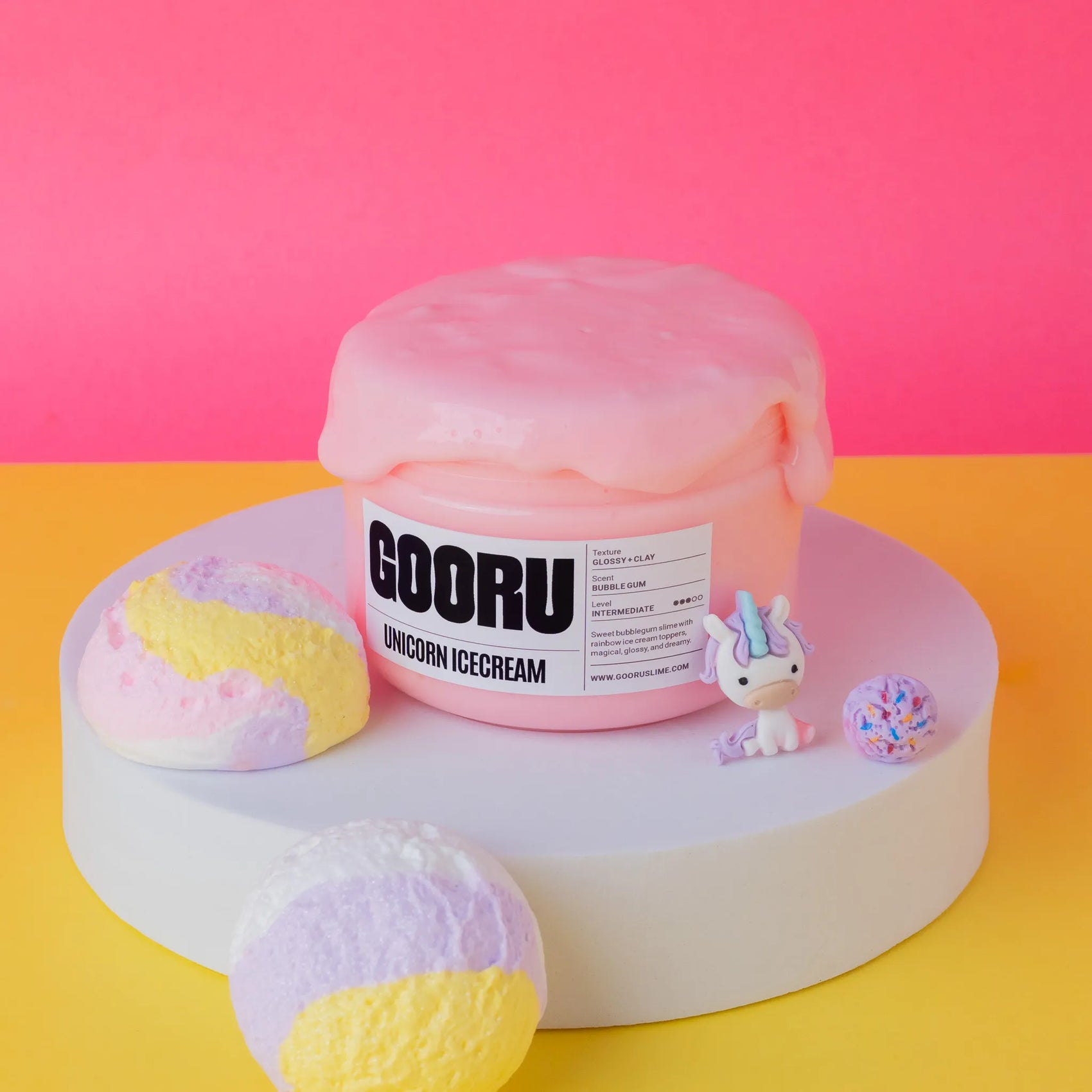 Pink slime container labeled 'GOORU Unicorn Ice Cream' with colorful ice cream-like objects on a pink and yellow background.