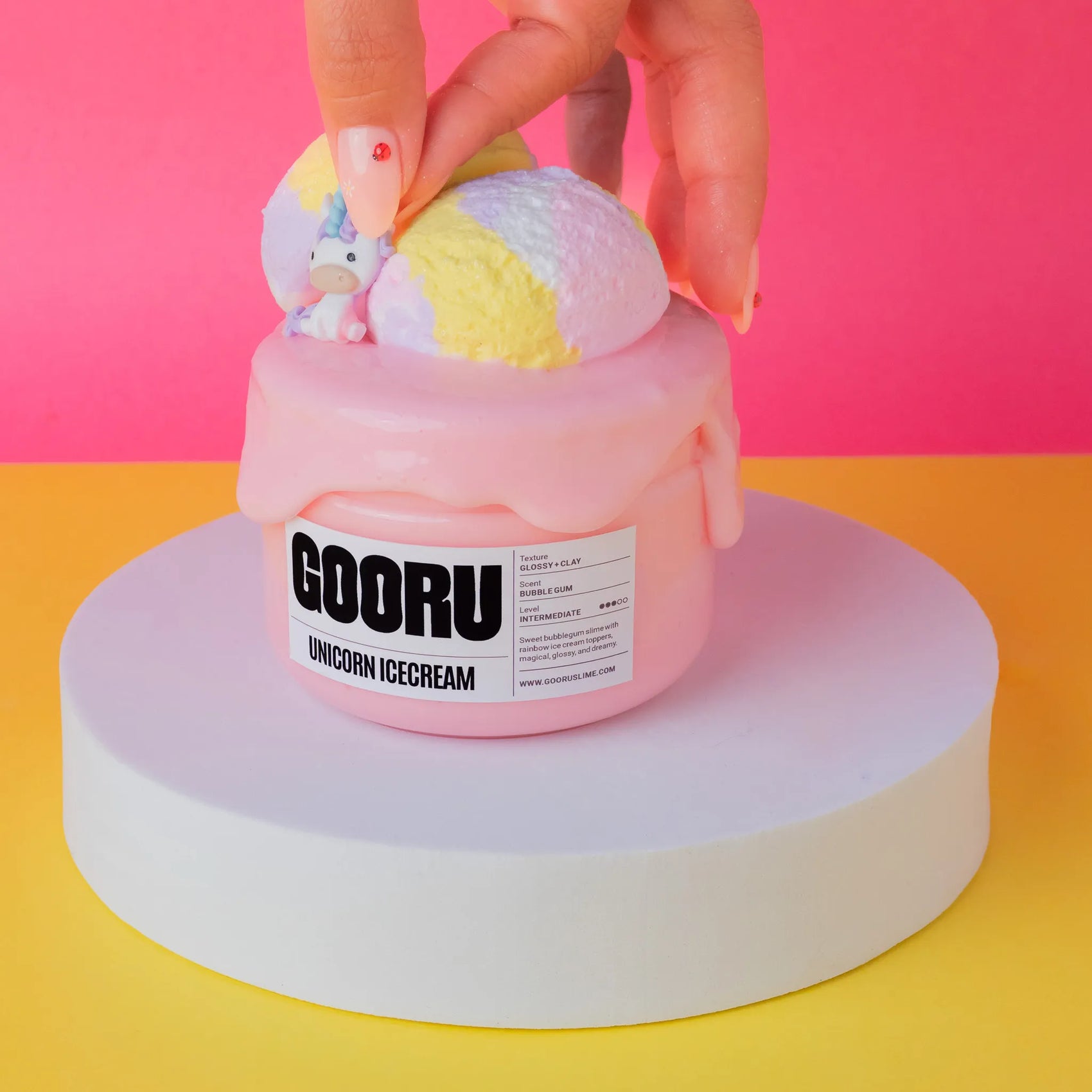 Pink slime resembling ice cream with 'GOORU' branding on a colorful background