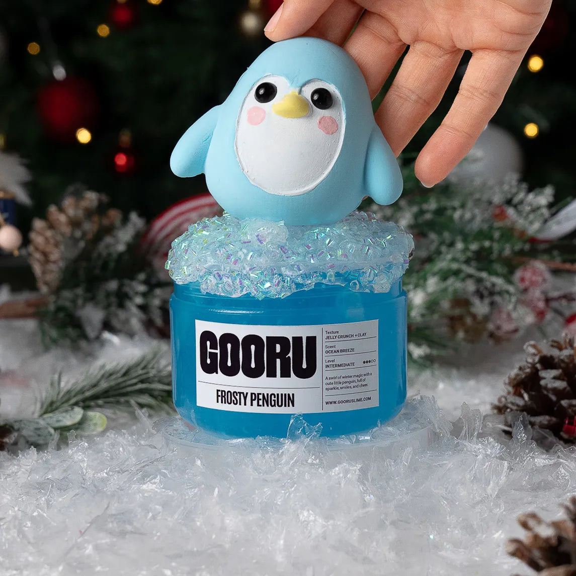 Blue penguin-shaped container with 'GOORU' label on a snowy background